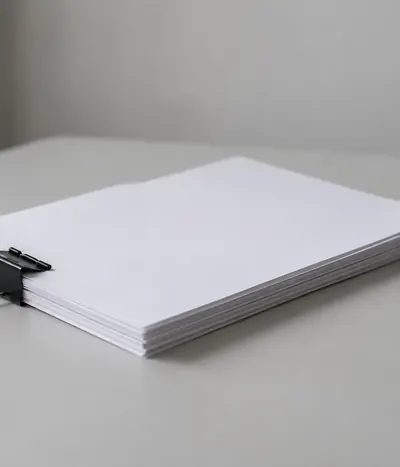 Stack of blank documents with a black binder clip