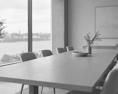 Empty meeting room with a long pale table